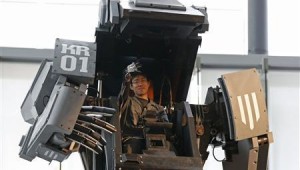 Robotics expert Yoshizaki demonstrates how to operate the arm of a giant "Kuratas" robot in Tokyo