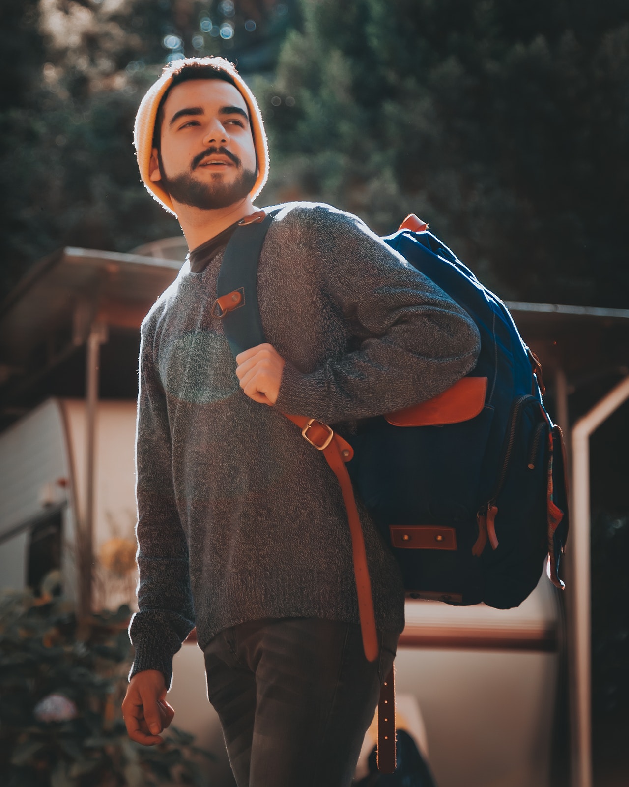 photo-of-man-in-gray-swearer-standing-outside-carrying-blue-2376999